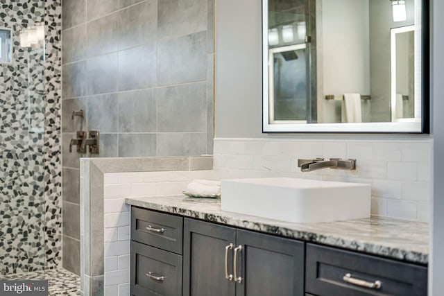 full bathroom with a walk in shower and vanity