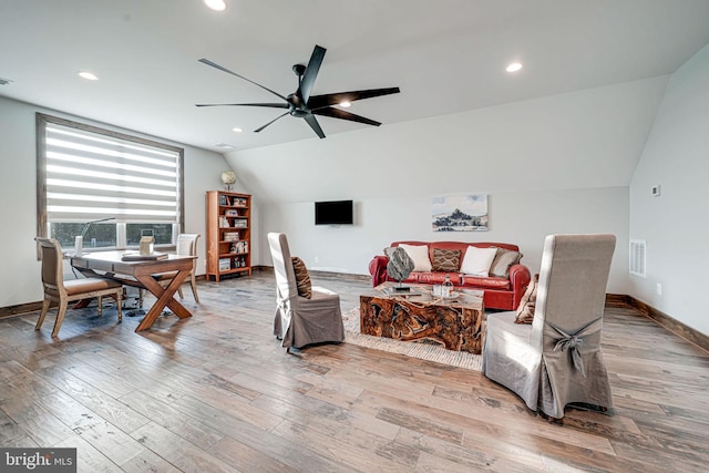 living room with visible vents, ceiling fan, vaulted ceiling, and baseboards