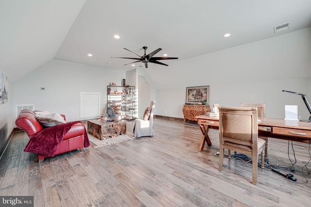 office area featuring ceiling fan, vaulted ceiling, wood finished floors, and visible vents