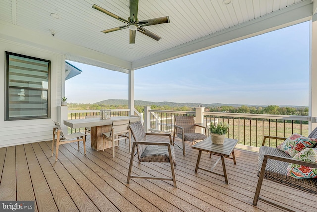 deck with a mountain view and ceiling fan