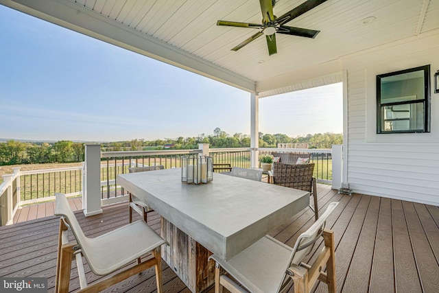 wooden deck with ceiling fan and outdoor dining space