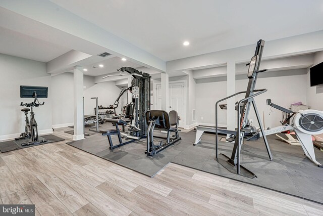 workout area with recessed lighting, visible vents, and wood finished floors