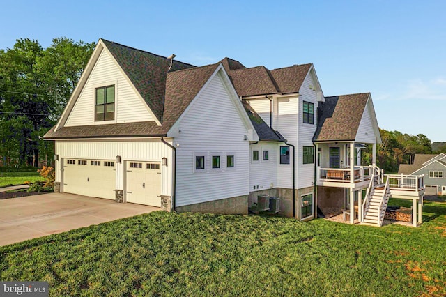 exterior space with a front yard, a shingled roof, a garage, stairs, and driveway