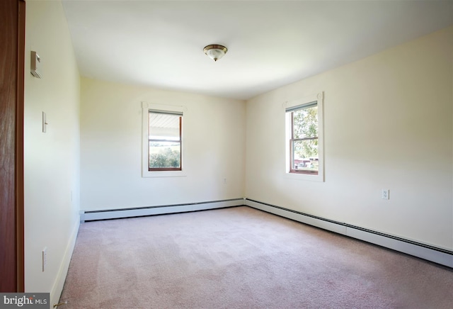 carpeted empty room featuring a baseboard radiator and baseboards