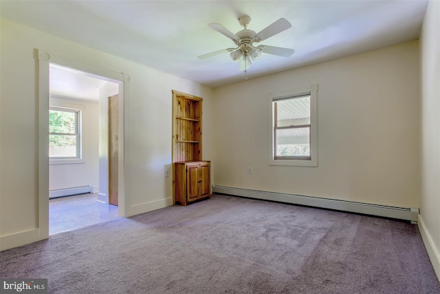 unfurnished room with baseboard heating, baseboards, carpet floors, and a ceiling fan