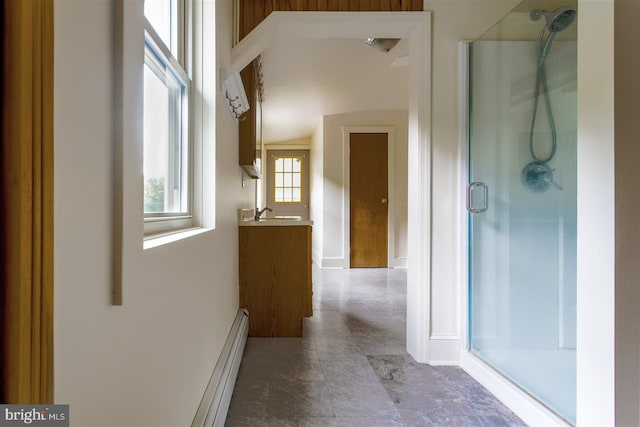 full bath featuring a baseboard radiator, vanity, and a stall shower