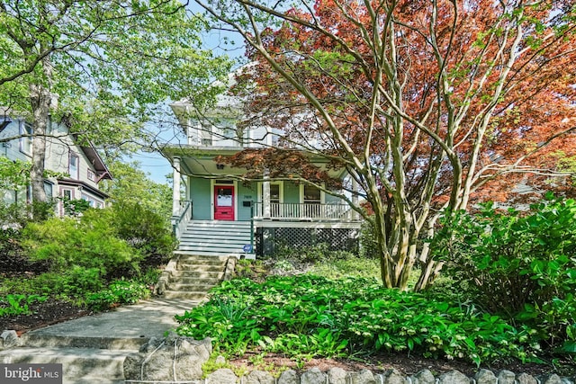 view of front of property featuring a porch and stairs