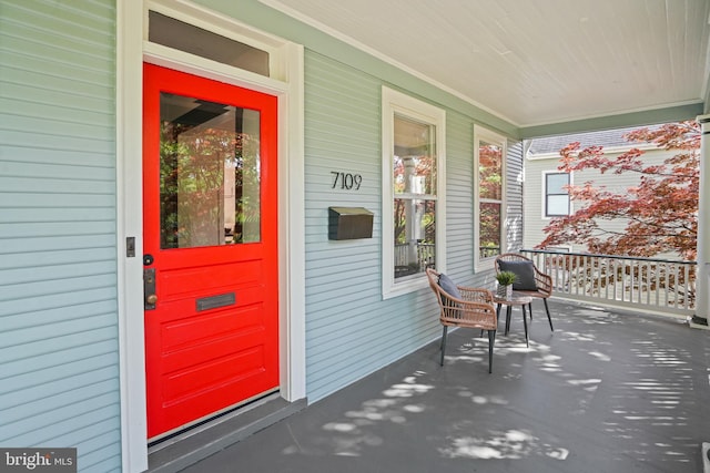 view of exterior entry featuring a porch
