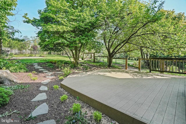 view of yard featuring a deck and fence