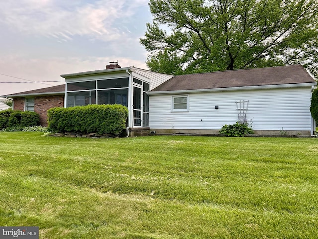 113 Edgeroad Ln, Wilmington, DE 19803 - back of property with a sunroom, a yard, and a chimney