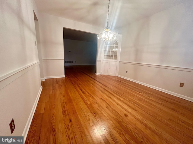 113 Edgeroad Ln, Wilmington, DE 19803 - unfurnished dining area featuring a chandelier, wood finished floors, and baseboards