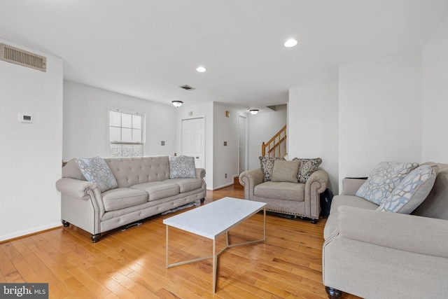 4045 Chetham Way, Woodbridge, VA 22192 - living room with stairway, light wood finished floors, baseboards, and visible vents