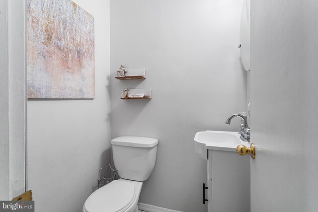 bathroom featuring toilet and vanity
