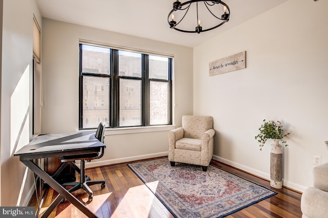 home office with an inviting chandelier, wood finished floors, and baseboards