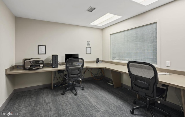 office space with dark carpet, baseboards, and visible vents