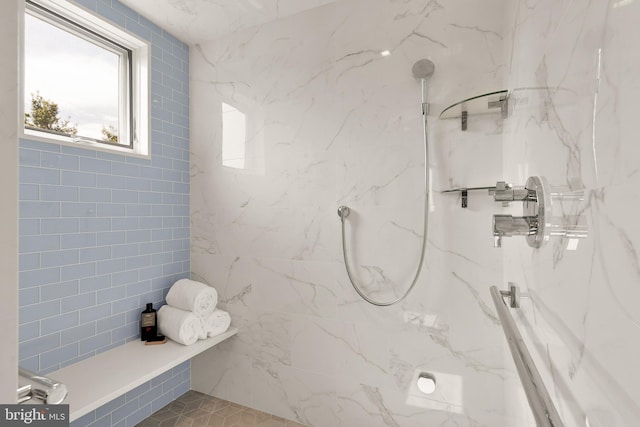 bathroom with a marble finish shower