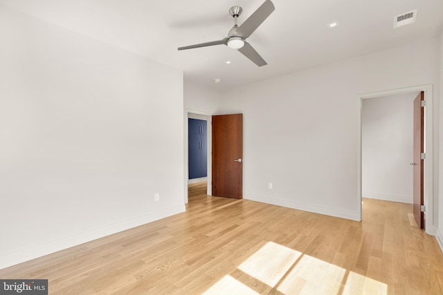 unfurnished bedroom featuring baseboards, ceiling fan, light wood-style flooring, and visible vents
