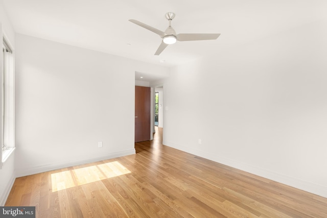 empty room with light wood-type flooring, baseboards, and ceiling fan