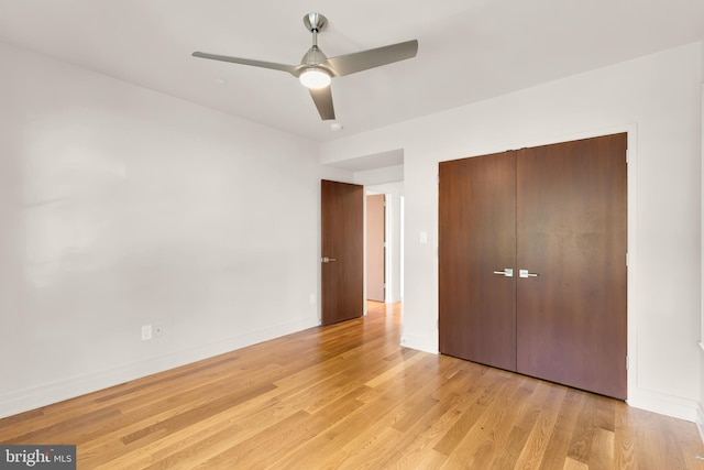 unfurnished bedroom with baseboards, ceiling fan, a closet, and light wood finished floors