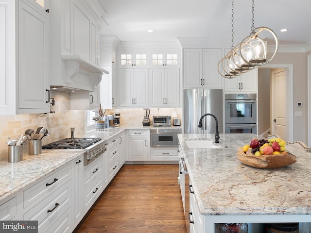 kitchen featuring a sink, white cabinetry, a kitchen island with sink, and stainless steel appliances