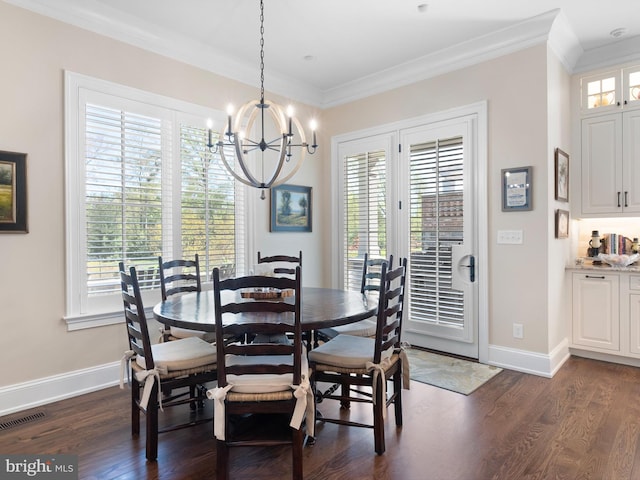 dining space featuring an inviting chandelier, a wealth of natural light, crown molding, and visible vents