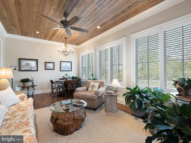 living room with ceiling fan with notable chandelier, baseboards, wooden ceiling, wood finished floors, and ornamental molding
