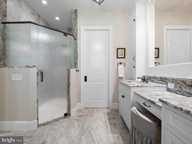 full bath with vanity, marble finish floor, baseboards, recessed lighting, and a stall shower