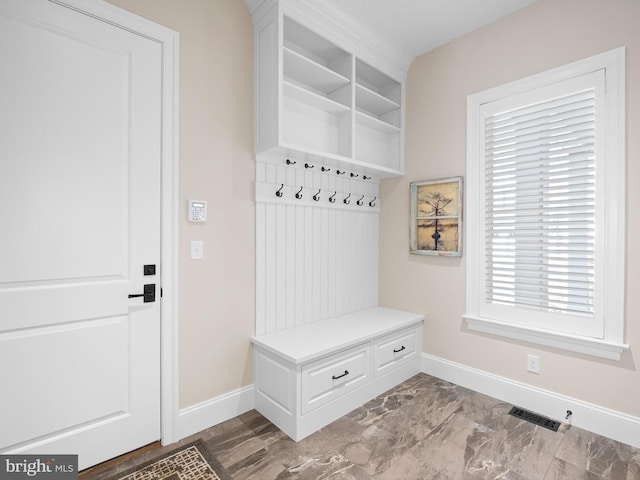 mudroom featuring baseboards, marble finish floor, and visible vents