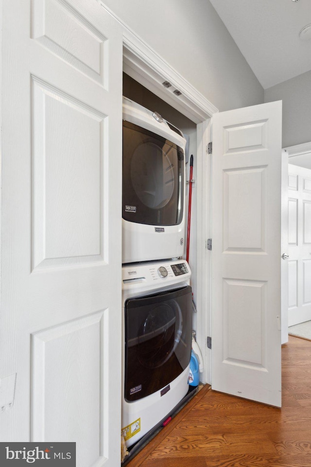 820 Belmont Bay Dr Unit 405, Woodbridge, VA 22191 - washroom with wood finished floors, stacked washer and clothes dryer, and laundry area