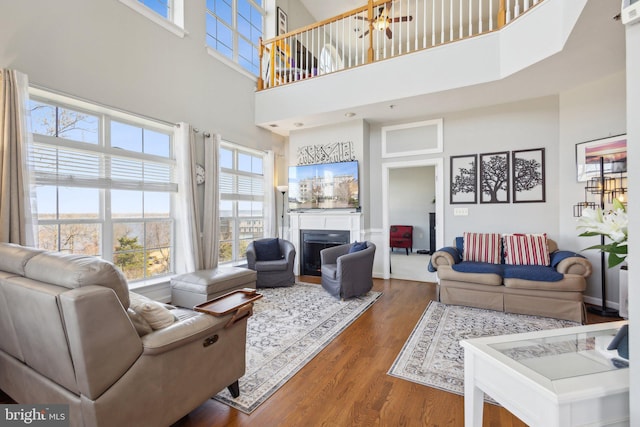 820 Belmont Bay Dr Unit 405, Woodbridge, VA 22191 - living area featuring a fireplace, wood finished floors, and a high ceiling