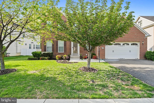 view of front facade with brick siding, an attached garage, driveway, and a front yard