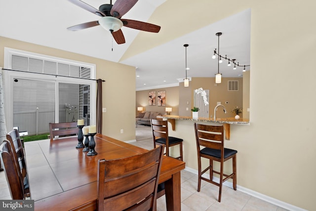 dining room with visible vents, baseboards, ceiling fan, rail lighting, and light tile patterned floors