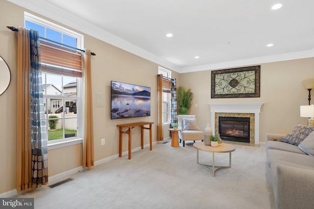 carpeted living room with visible vents, a high end fireplace, baseboards, and plenty of natural light