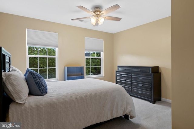 bedroom featuring carpet floors, multiple windows, baseboards, and visible vents
