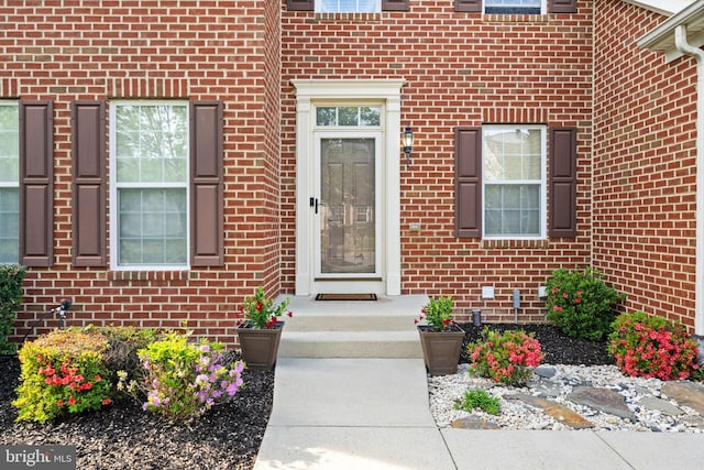property entrance with brick siding