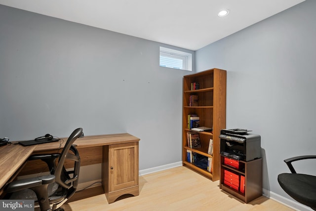 office space with baseboards, recessed lighting, and light wood-type flooring