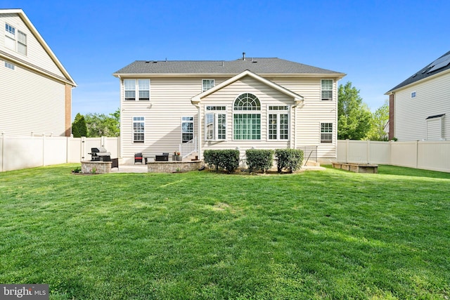back of house with a lawn, a patio, and a fenced backyard
