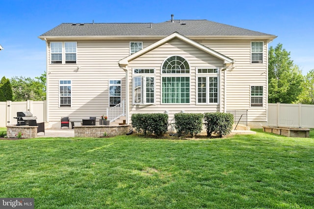 back of house with a lawn, fence, and a patio area