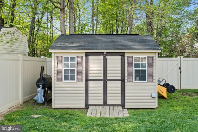 view of shed with a gate and a fenced backyard
