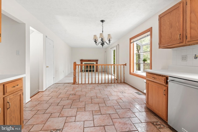 8005 Hillrise Ct, Elkridge, MD 21075 - kitchen featuring stainless steel dishwasher, light countertops, a chandelier, decorative backsplash, and light stone finish floors
