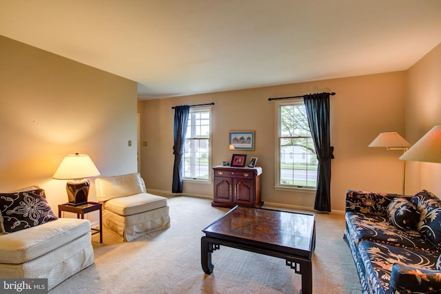 carpeted living room with baseboards