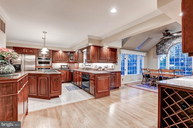 14712 Manor Rd, Phoenix, MD 21131 - kitchen with appliances with stainless steel finishes, ceiling fan, a sink, light wood finished floors, and a center island