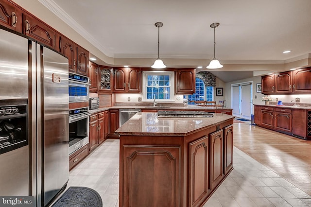 14712 Manor Rd, Phoenix, MD 21131 - kitchen with appliances with stainless steel finishes, a center island, a sink, crown molding, and dark stone counters