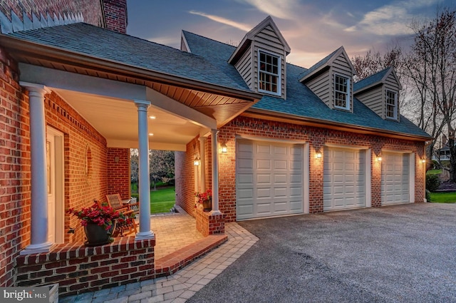 14712 Manor Rd, Phoenix, MD 21131 - garage at dusk featuring asphalt driveway