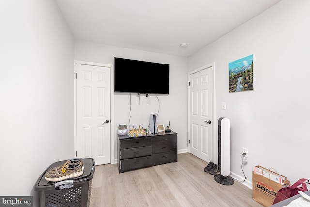 bedroom featuring baseboards and light wood-style floors