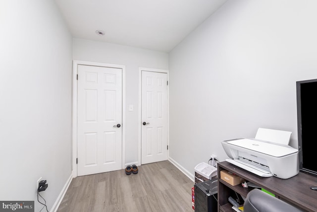 home office featuring baseboards and wood finished floors