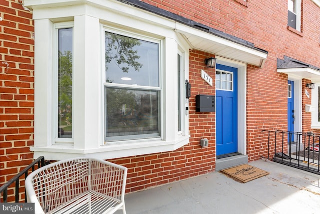 view of exterior entry with brick siding