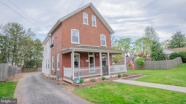 718 Walnut St, Royersford, PA 19468 - view of front facade with covered porch, brick siding, and driveway