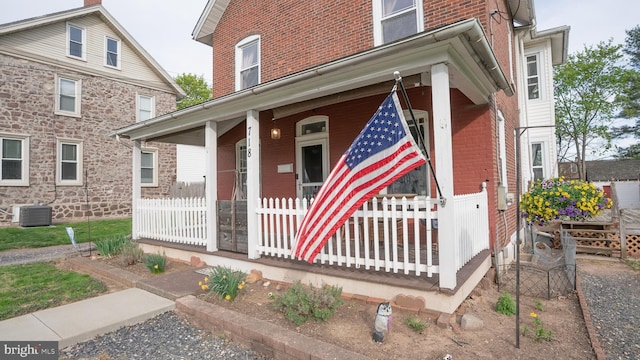 718 Walnut St, Royersford, PA 19468 - view of front of house with a porch, brick siding, and central AC