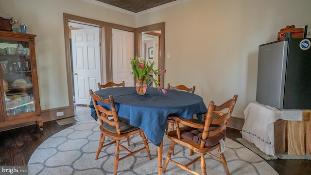 718 Walnut St, Royersford, PA 19468 - dining space featuring wood finished floors, crown molding, and baseboards